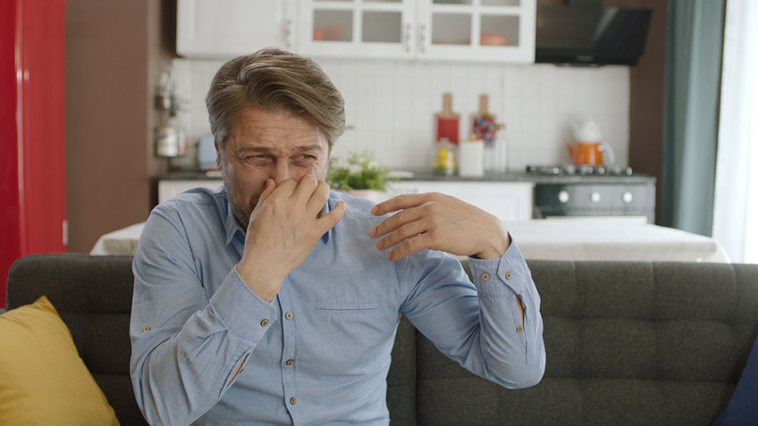 person covering their nose due to drain odors Summerlin, NV