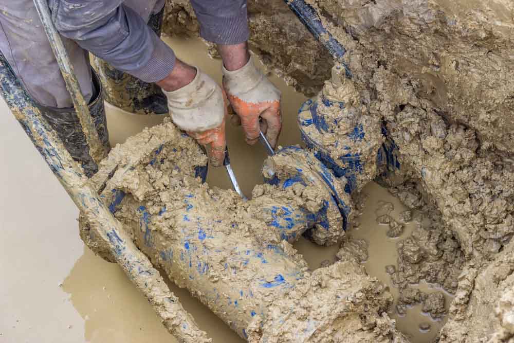 plumber fixing the broken commercial pipes