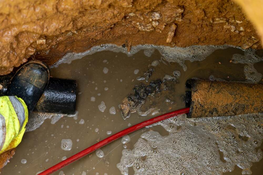 technician performing hydro jetting on clogged sewer line